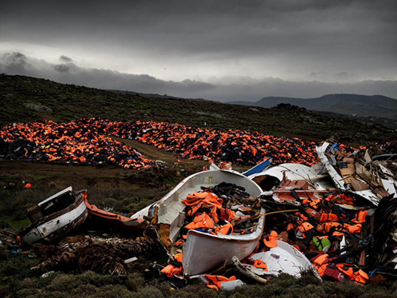 The debris of displacement: Thousands of discarded life jackets and plastic boats sits on a hillside on the Greek island of Lesbos. 