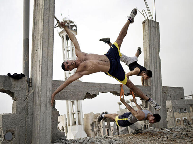 Palestinian men practice street workouts, using the rubble of war-torn Gaza as their gym. 