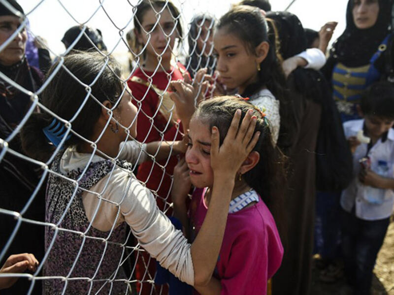 Displaced Iraqi families are reunited after fleeing violence in Mosul. 