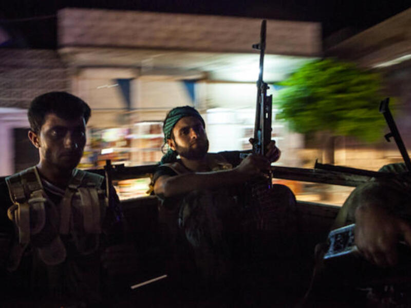 Syrian rebels head to the town of Bsankol in the northwestern province of Idlib to join comrades fighting regime forces for the control of the highway that connects Idlib with Latakia on July 11, 2013. (Source: AFP/DANIEL LEAL-OLIVAS)