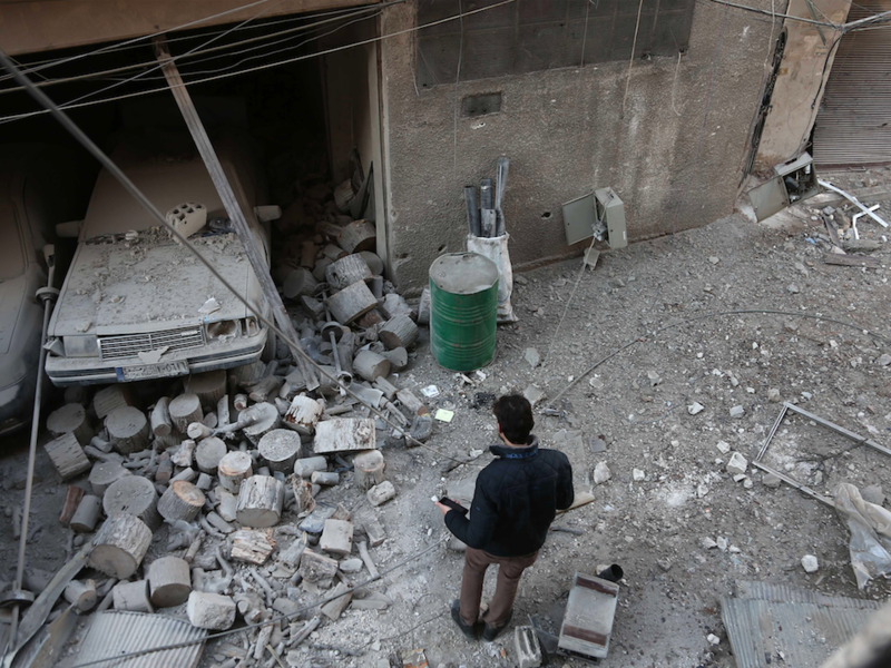 A Syrian civilian inspects the damage following government bombing in the rebel-held town of Hamouria, in the besieged Eastern Ghouta region on the outskirts of the capital Damascus, on Feb. 19, 2018. 
(ABDULMONAM EASSA / AFP)