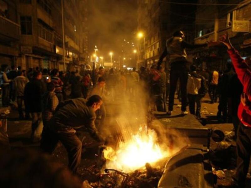 Egyptian Christians burn trash containers during a protest late near the Al-Qiddissine church.