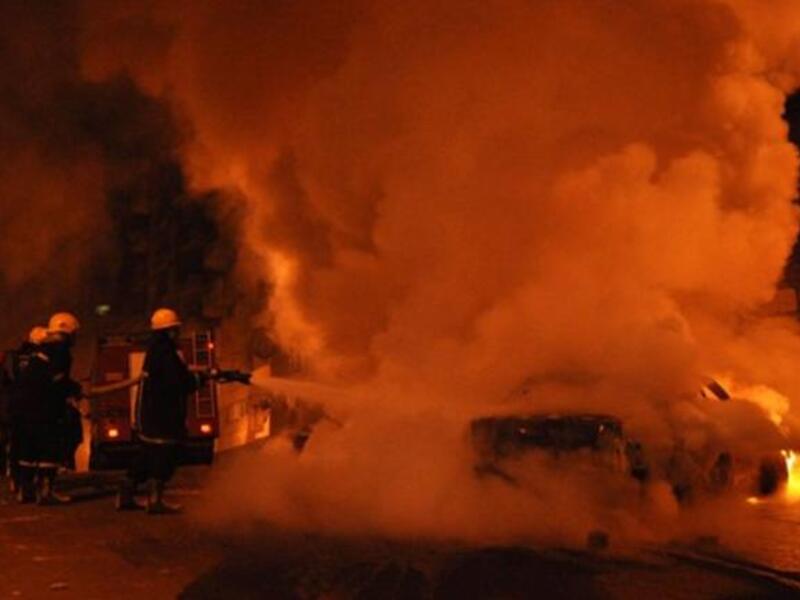 Egyptian firefighters extinguish flames from a vehicle that caught fire following a car bomb attack outside the Al-Qiddissine church.