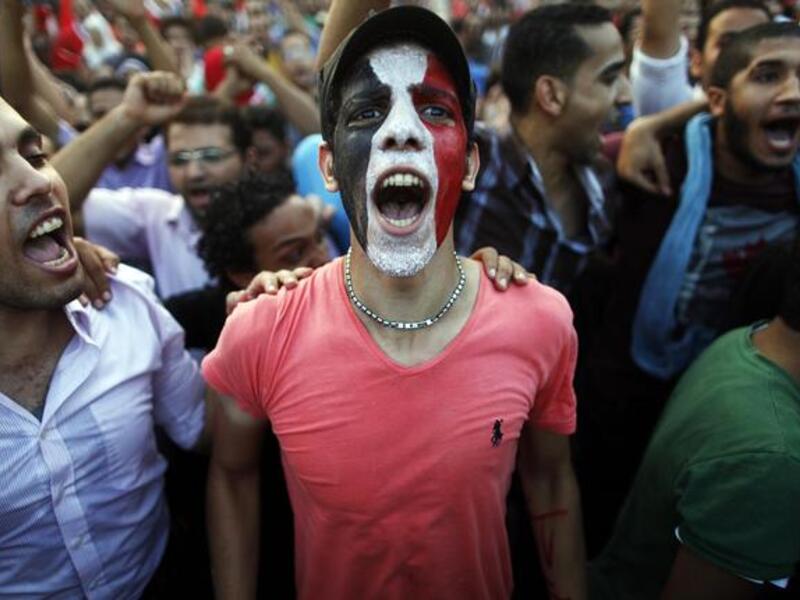 Egyptians shout slogans against President Mohamed Morsi and the Muslim Brotherhood as hundreds of thousands of Egyptian demonstrators gather at the presidential palace during a protest calling for the ouster of Morsi on July 1, 2013 in Cairo.
