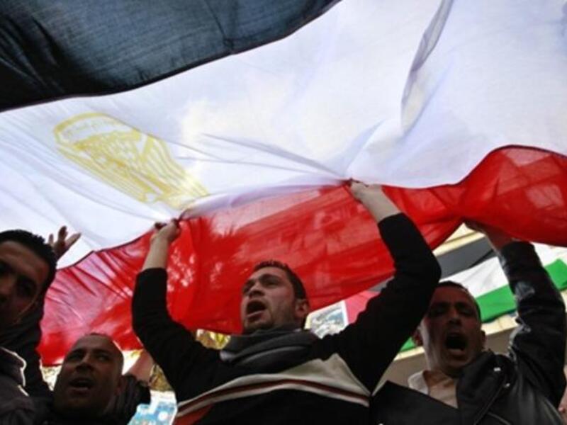 Jordanians side by side of Egyptians working in Jordan raise the Egyptian flag to salute the exit from power of a former unpopular leader.