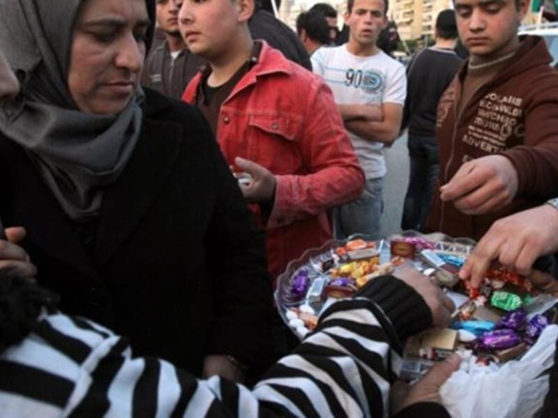 In Lebanon, sweets are distributed outside the embassy in Beirut to celebrate the sweet victory marked by the resignation of Egypt's Hosni Mubarak, President of the Republic of Egypt, Friday, February 11, 2011.