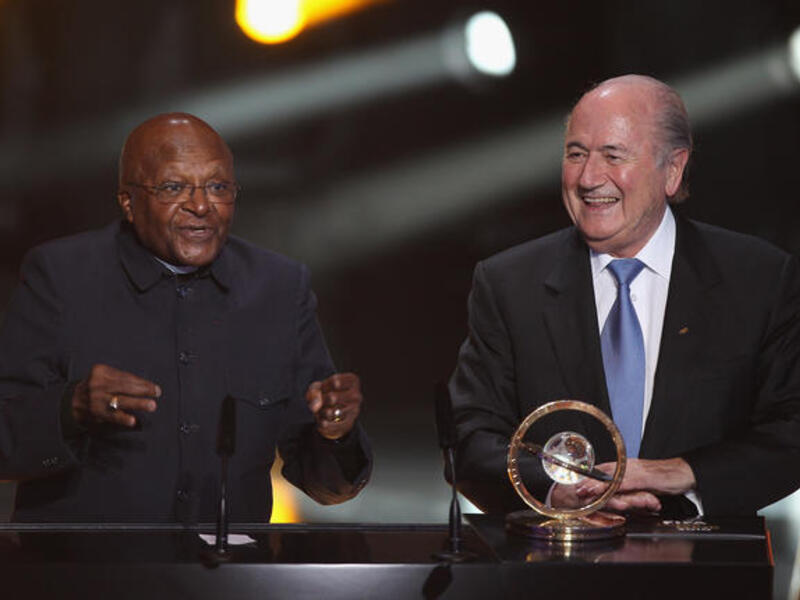 Archbishop Desmond Tutu (L) of South Africa receives the Presidential award from Sepp Blatter (R) President of FIFA.