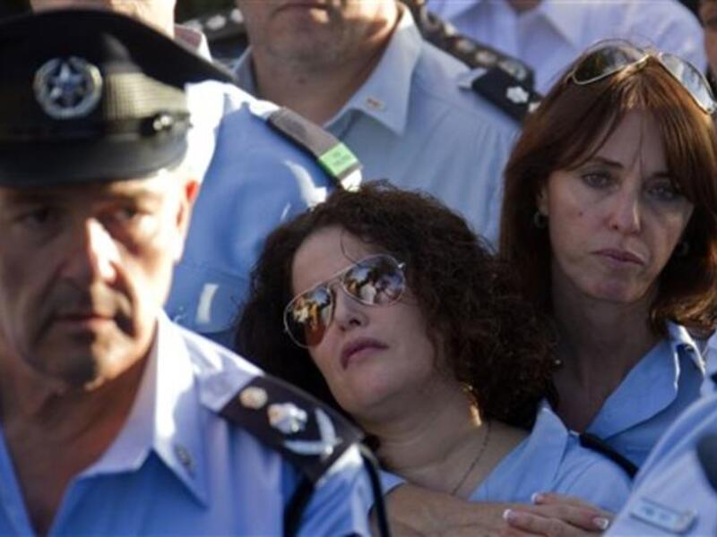 Israeli police officers mourn during the funeral of their comrade, Haifa Police Chief Ahuva Tomer. The death toll from Israelv massive forest fire rose to 42 with the death of Tomer, Israeli public radio reported.