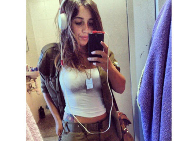 Hipster IDF girl doesn’t care what you have to say. She’s too busy flashing the tat and listening to the national anthem.