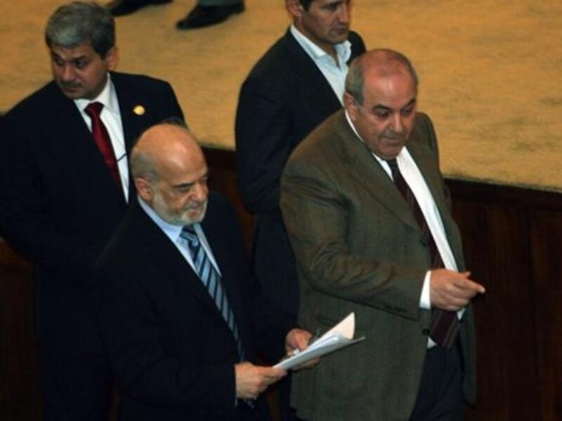 Iraqi former prime minister and now member of Parliament and head of the Iraqiya bloc Iyad Allawi (R) and former Iraqi prime minister Ibrahim al-Jaafari, now member of Parliament and of the National alliance, walk together in parliament.