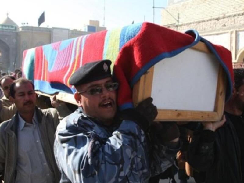 Iraqi mourners carry the coffin of a victim of a spate of blasts that hit across Iraq.
