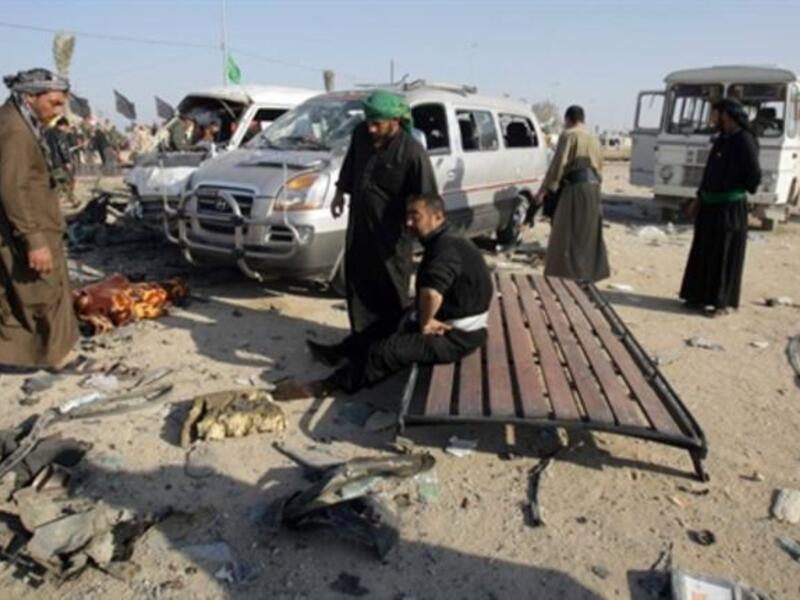 People gather on the site of an explosion.