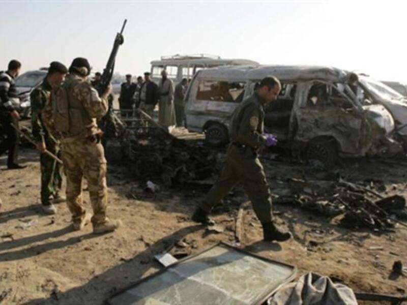 Members of Iraq security forces gather on the site of an explosion in Karbala. As a spate of attacks across Iraq killed at least 50 people, most of them in twin suicide car bombings in the holy city of Karbala, the third major attack in as many days.