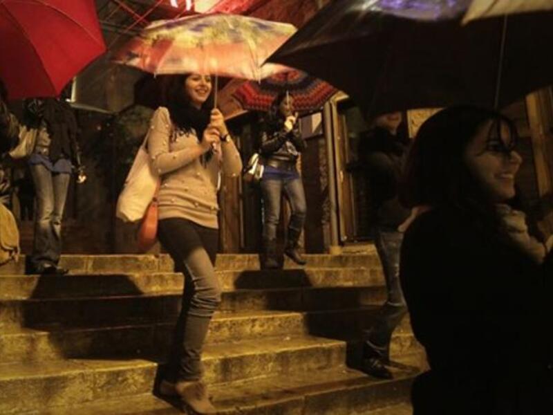 Lebanese women perform a dance in a street as rain approaches the mediterranean country after several months of drought.