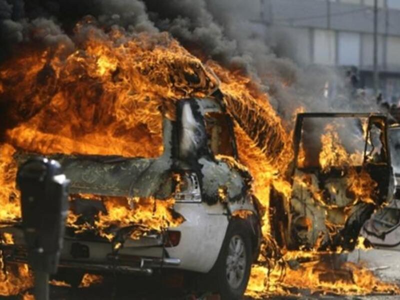Supporters of the Future Movement torch the vehicle belonging to the Arabic language al-Jazeera satellite television station during a demonstration in support of the caretaker prime minister Saad Hariri in the Sunni bastion coastal city of Tripoli.