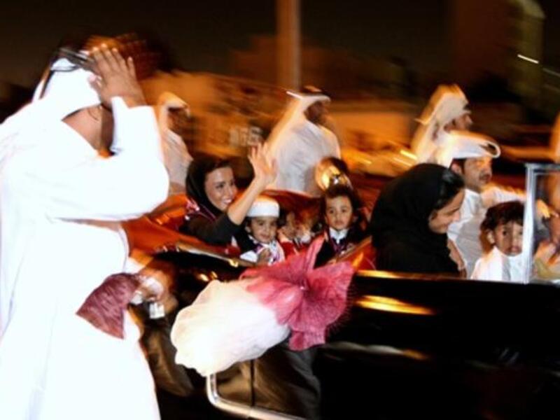 Sheikha Moza bint Nasser al-Missned (car L), wife of Qatari Emir Sheikh Hamad bin Khalifa al-Thani, waves to the crowds as she arrives with her grandchildren to Doha coming from Zurich.