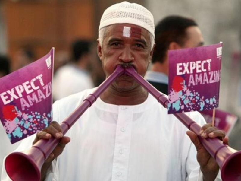 A Qatari man blows vuvuzela trumpets at Doha's traditional souk as people gather to follow FIFA's decision on who will host the 2022 World Cup.