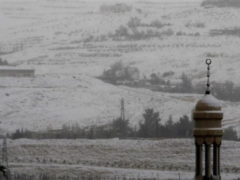 Snow covers the minaret of a mosque in Damascus as the Syrian capital was lashed by a snowstorm which disrupted traffic but brought some relief from a drought which has gripped the country for the past four years.
