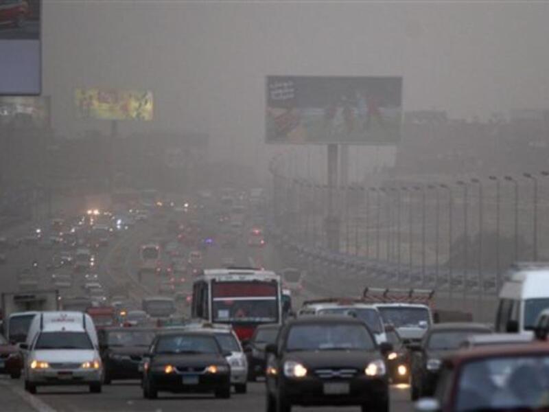 Cars drive amid fog covering Cairo. A sandstorm, strong winds and lashing rains swept across Egypt, closing several ports and disrupting traffic in the Suez Canal while at least three people died in a factory collapse in the Mediterranean city of Alexandria, officials said.