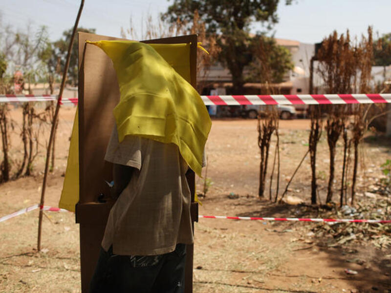 A man votes at a polling station.