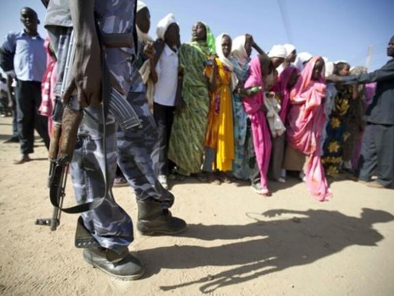 Sudanese policeman standing guard as students gather to protest against the visit of Darfur mediators from Qatar and the UN outside the University of Zalingei.