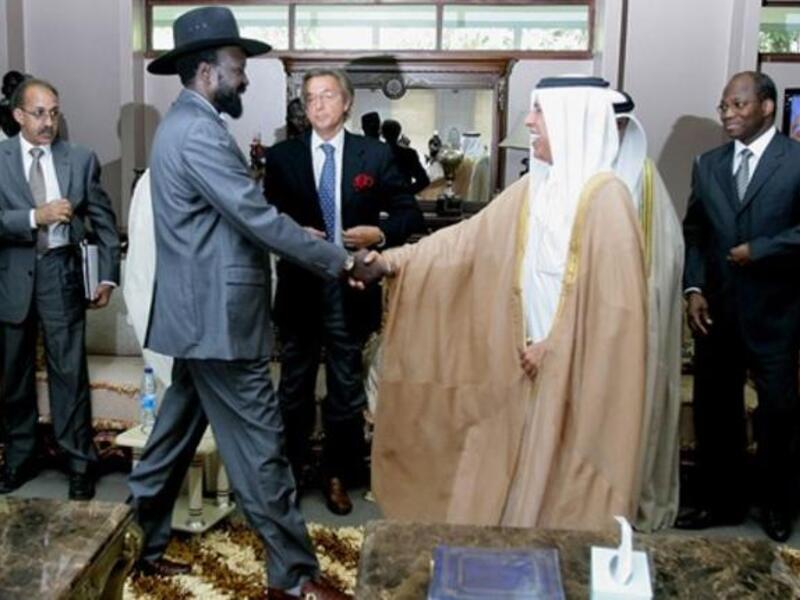Qatari Minister of State for Foreign Affairs Ahmed bin Abdullah al-Mahmud (C-R) shakes hands with South
Sudan leader Salva Kiir as he arrives with Djibril Bassole, chief negotiator for the UN and the African Union for a meeting in south Sudan's regional capital Juba.