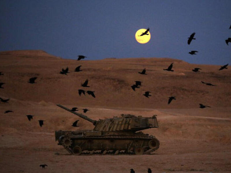 A picture taken on June 23, 2013 shows a full moon rising the "Judean Desert" in the Israeli occupied Palestinian West Bank.