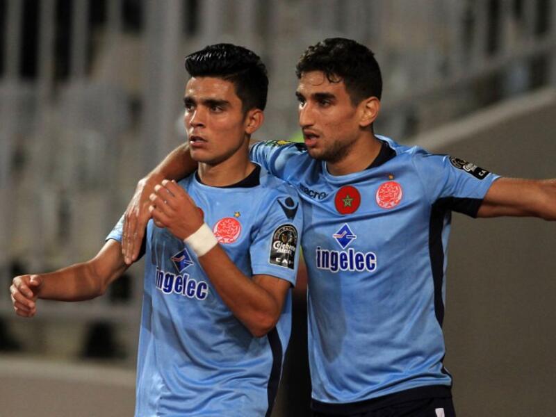 Wydad's striker Achraf Bencharki (L) celebrates his equalising goal with his teammate during the CAF Champions League final football match between Al-Ahly vs Wydad Casablanca at the Borg El Arab Stadium in Alexandria on October 28, 2017.
STRINGER / AFP