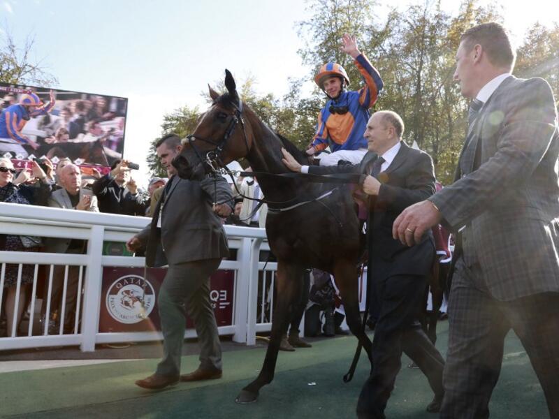 Britain's Ryan-Lee Moore (L) waves on his horse 'Found' as he celebrates winning the 95th Qatar Prix de l'Arc de Triomphe horse race at the Chantilly racecourse, northern France, on October 2, 2016.
JACQUES DEMARTHON / AFP