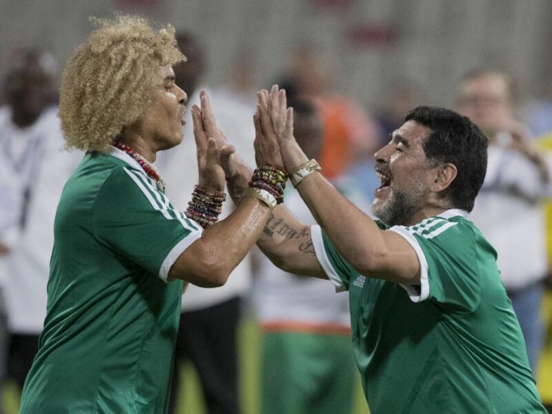 CONMEBOL player Diego Maradona (R) and Carlos Valderrama (L) celebrate a goal during a FIFA Legends football game on May 10, 2017 in Manama, Bahrain.
JACK GUEZ / AFP