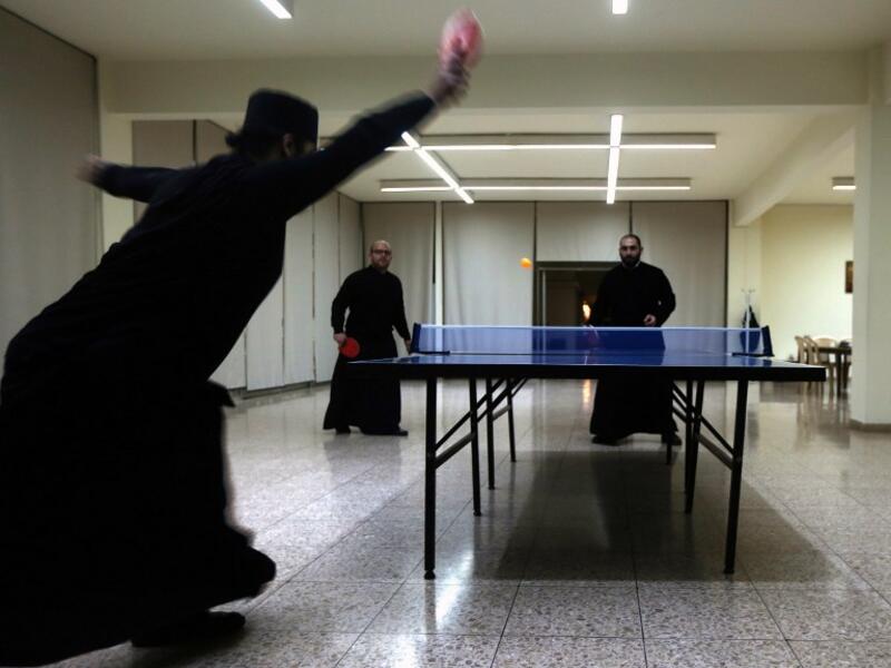 Greek Orthodox priests play tennis table during a break from their studies at the St. John of Damascus Institute of Theology in Balamand in northern Lebanon on March 2, 2016. The institute was established in 1832 and hosts students from all over the world.

PATRICK BAZ / AFP