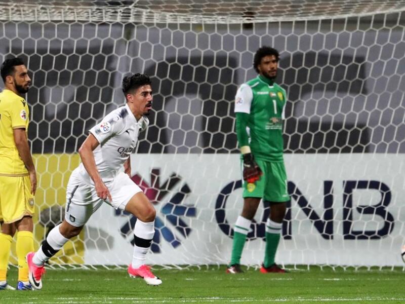 Qatar's al-Sadd player Baghdad Bounedjah (C) celebrates after scoring a goal during the AFC Champions League group stage football match between al-Wasl and al-Sadd at the Zabeel Stadium in Dubai on February 13, 2018.
KARIM SAHIB / AFP