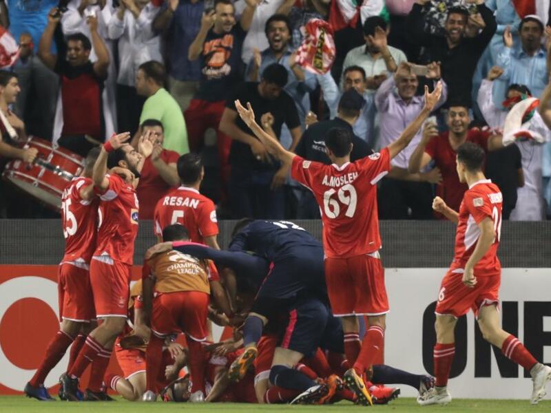 Persepolis FC's Ali Alipour (unseen) celebrates with teammates after scoring during the AFC Champions League semi-final first leg match between Al-Sadd SC FC and Persepolis FC at the Jassim Bin Hamad Stadium in Doha on October 2, 2018.
KARIM JAAFAR / AFP