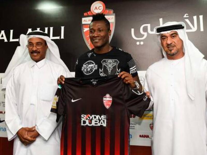 Asamoah Gyan, new signing of Al Ahli club with CEO Obaid Saeed and team manager Abdul Majid Hussain at a media conference in Dubai (Photo: Gulf News)