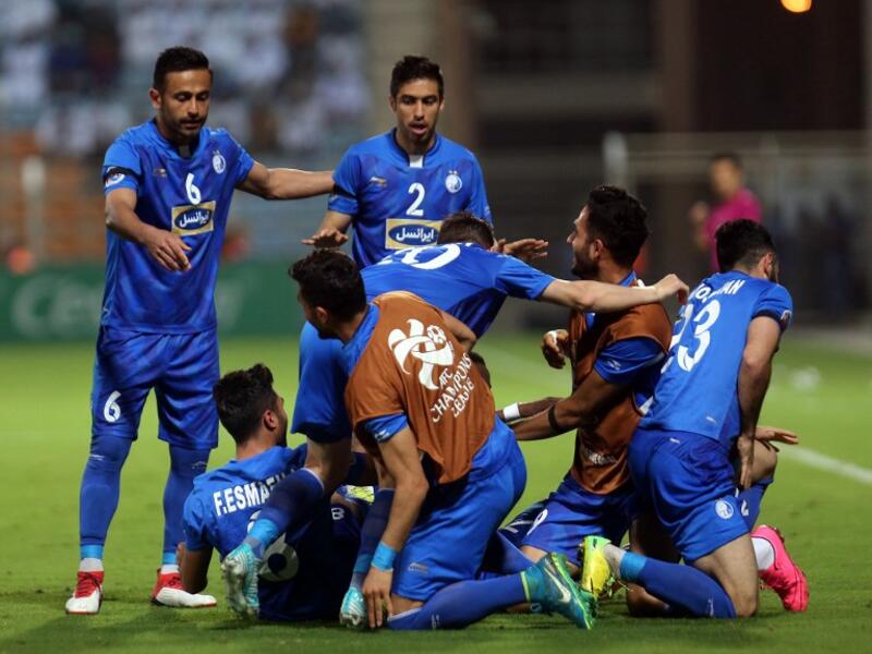 Iranian club Esteghlal's players celebrate after scoring a goal against Saudi club Al-Hilal during their Asian Champions League football match on February 20, 2018 at al-Seeb stadium in Muscat.
MOHAMMED MAHJOUB / AFP