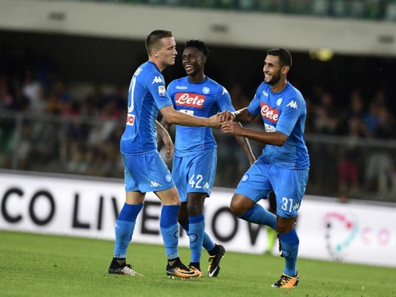 Napoli's Algerian defender Faouzi Ghoulam (R) celebrates after scoring a goal during the Italian Serie A football match Hellas Verona vs Napoli at the Marcantonio Bentegodi stadium in Verona on August 19, 2017.
MIGUEL MEDINA / AFP