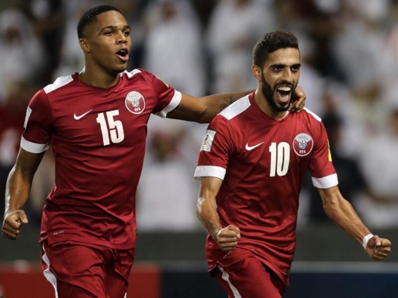 Qatar's Hasan al-Haydos (R) celebrates after scoring a penalty during the 2018 World Cup qualifying football match between Qatar and Syria at the Jassim Bin Hamad Stadium in Doha on October 11, 2016.
KARIM JAAFAR / AFP