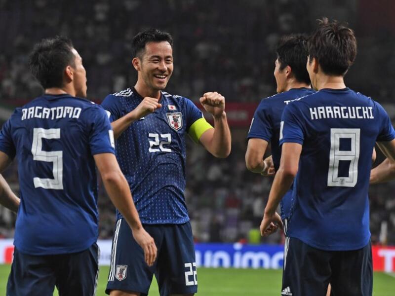 Japan's midfielder Genki Haraguchi (R) is congratulated for his goal during the 2019 AFC Asian Cup semi-final football match between Iran and Japan at the Hazza Bin Zayed Stadium in Abu Dhabi on January 28, 2019.
Roslan RAHMAN / AFP
