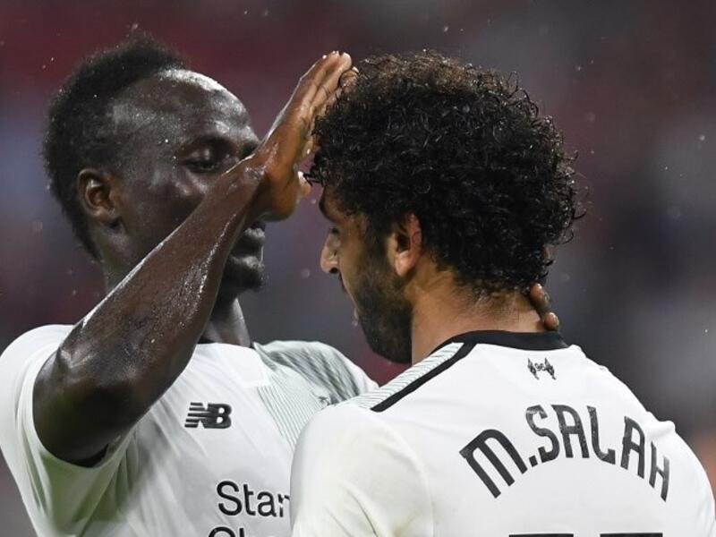 Liverpool's Senegalese striker Sadio Mane (L) and his teammate Liverpool's Egyptian striker Mohamed Salah (R) react after the second goal for Liverpool during the second Audi Cup football match between FC Bayern Munich and FC Liverpool in the stadium in Munich, southern Germany, on August 1, 2017.
Christof STACHE / AFP