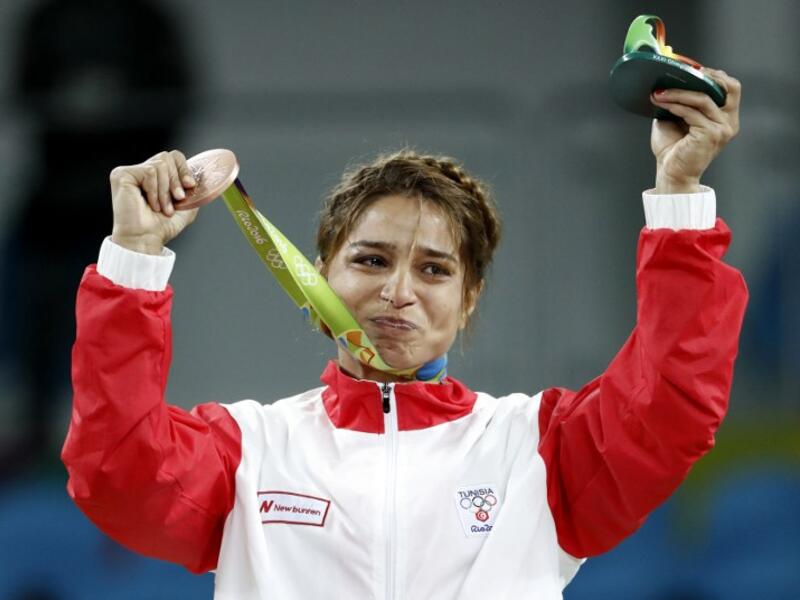 Tunisia's bronze medallist Marwa Amri reacts on the podium at the end of the women's 58kg freestyle wrestling event at the Carioca Arena 2 in Rio de Janeiro on August 17, 2016, during the Rio 2016 Olympic Games.
Jack GUEZ / AFP