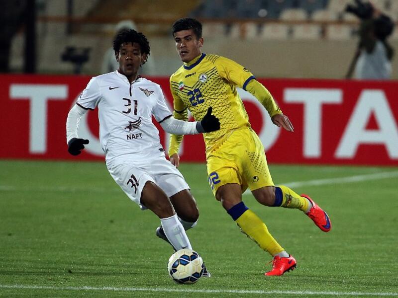 Naft Tehran's Reza Aliyari (L) and Qatar's El Jaish player Ricardo Romarinho chase the ball during AFC Champions League 3rd qualifying round play-off football match at the Azadi stadium in Tehran on February 9, 2016. 