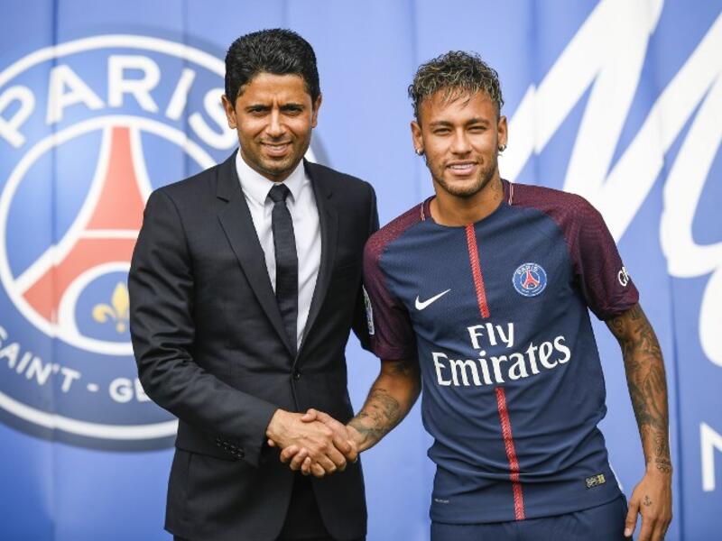 Brazil's Neymar (R) shakes hands with Paris Saint Germain's (PSG) Qatari president Nasser Al-Khelaifi during a press conference at the Parc des Princes stadium on August 4, 2017 in Paris after agreeing a five-year contract following his world record 222 million euro ($260 million) transfer from Barcelona to PSG. 
Lionel BONAVENTURE / AFP