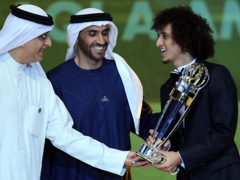 Shaikh Salman bin Ebrahim Al Khalifa (L), President of the Asian Football Confederation, and Sheikh Nahyan Bin Zayed Al Nahyan (C), Chairman of the Abu Dhabi Sports Council, present Omar Abdulrahman (R) with the AFC Men's Footballer of the Year trophy during the Asian Football Confederation's Annual Awards ceremony in Abu Dhabi.
NEZAR BALOUT / AFP