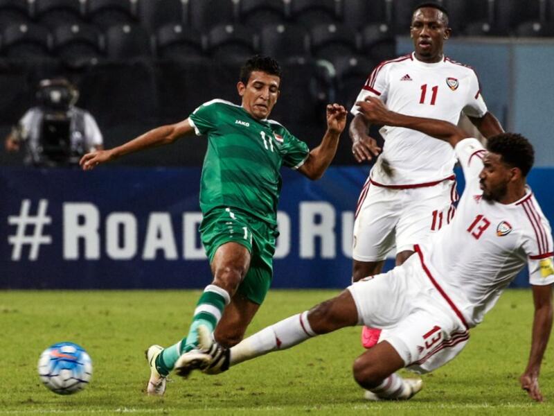 Iraq's Amjed Attwan (L) is tackled by UAE's Khamis Esmaeel during the 2018 World Cup qualifying football match between Iraq and the United Arab Emirates at Sheikh Mohammed Bin Zayed stadium in Abu Dhabi on November 15, 2016. Karim Sahib / AFP