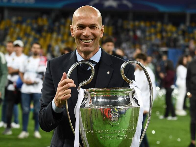 Real Madrid's French coach Zinedine Zidane holds the trophy as he celebrates winning the UEFA Champions League final football match between Liverpool and Real Madrid at the Olympic Stadium in Kiev, Ukraine, on May 26, 2018.
FRANCK FIFE / AFP