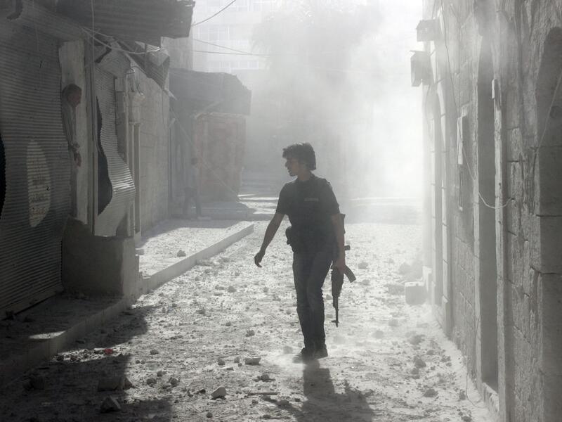 A soldier stands among debris inside Syria (AFP/FILE)