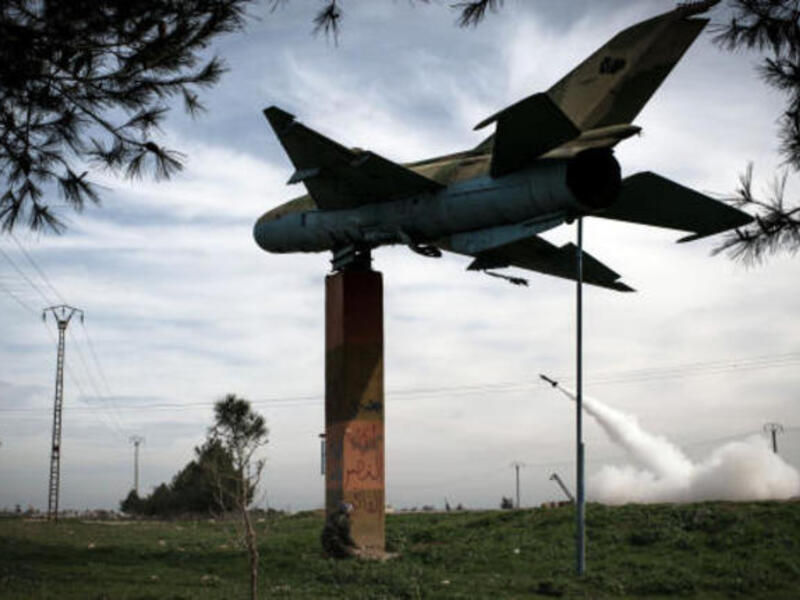 Syrian rebels fire a rocket towards regime forces stationed at Kwiriss airport in Al-Bab, 30 k from Aleppo, in this image from early 2013. [Getty]
