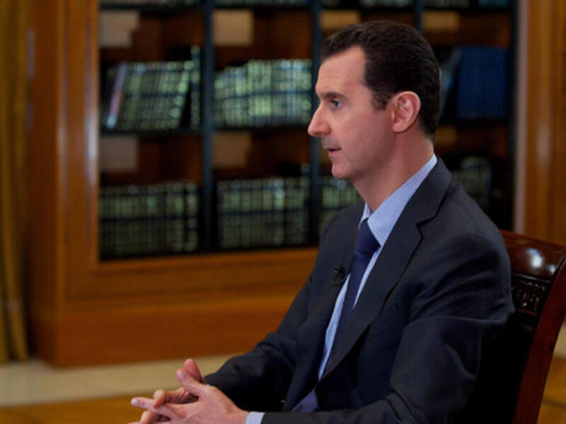 A handout picture released by the official Syrian Arab News Agency (SANA) on October 21, 2013, shows Syrian President Bashar al-Assad giving an interview. (Image credit: AFP)