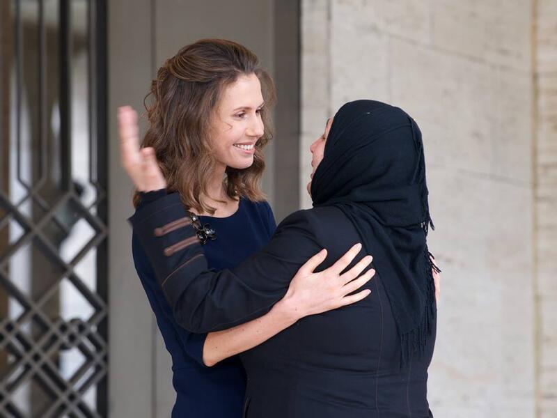 Asma al-Assad greets a Syrian woman, 21 March. (Syrian Presidency)