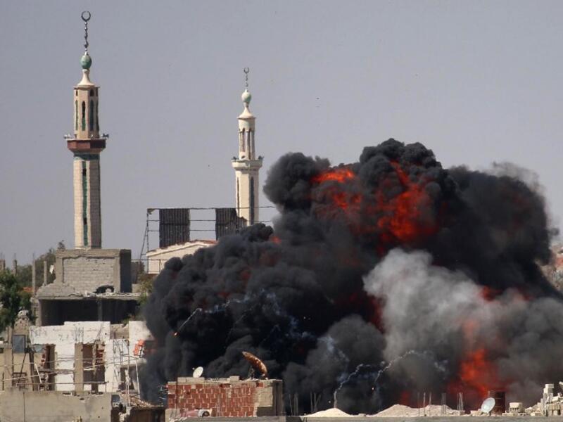 A ball of fire rises from a building following a reported air strike by Syrian government forces on a rebel-held area in the southern city of Daraa, on June 11, 2017. (Mohamad Abazeed/AFP)
